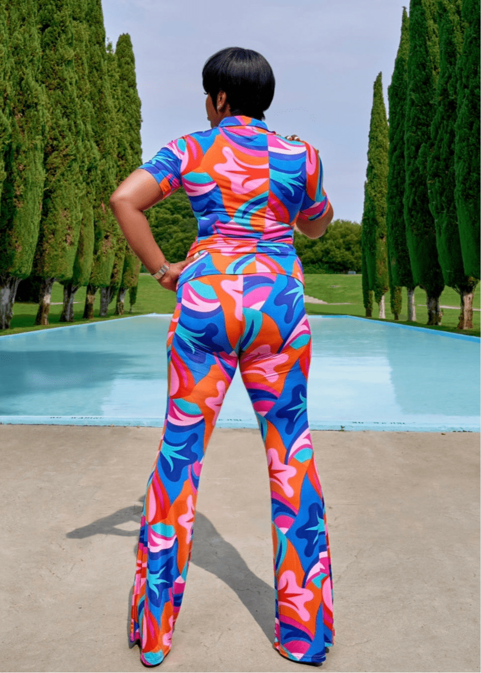 Back view of multicolor wide-leg pants set – bold floral print two-piece outfit styled for confident summer fashion, ideal for resort wear and poolside looks by Opulent Gurlz.