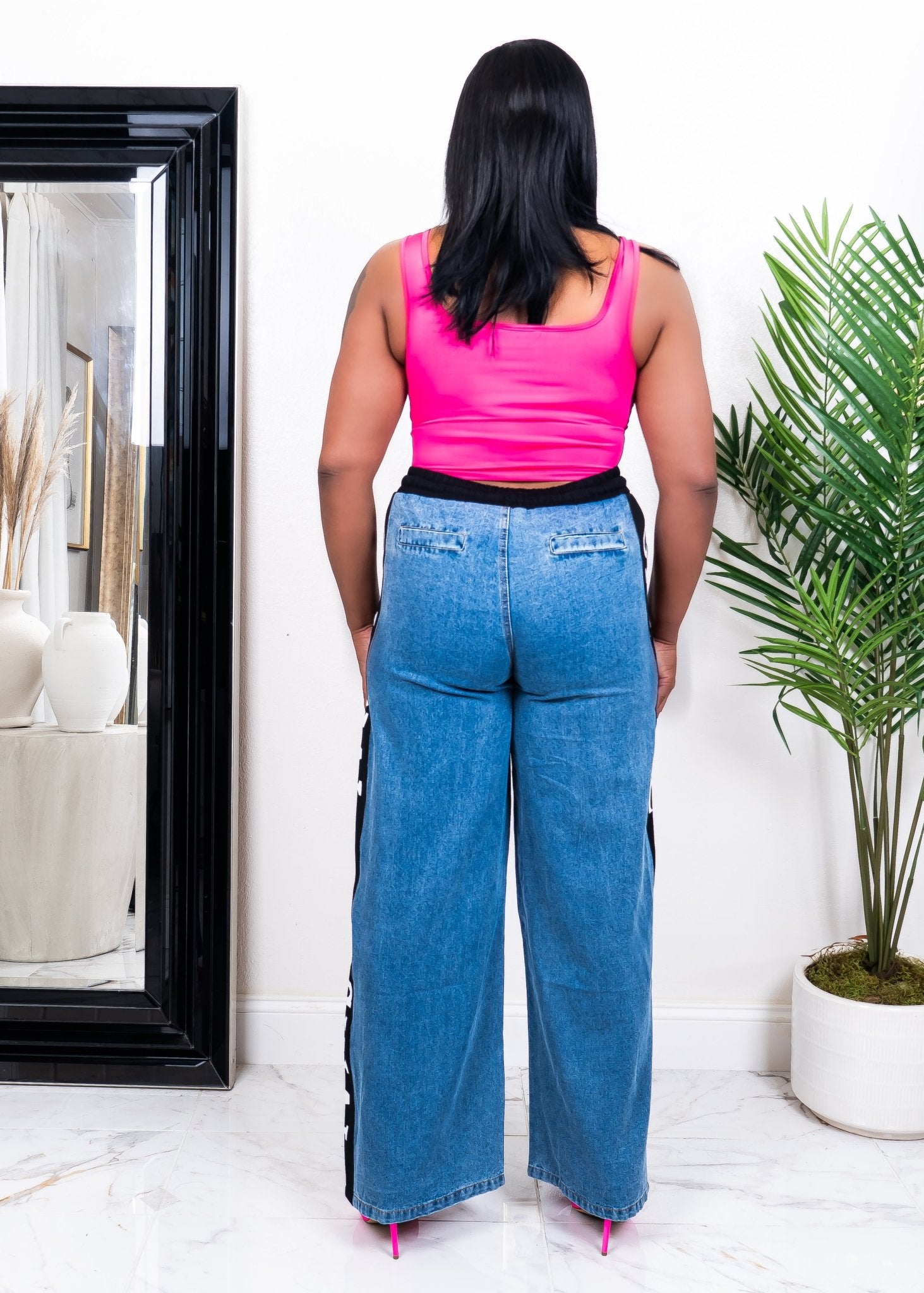 Back view of women’s wide-leg denim jeans with “ORIGINAL” lettering – curvy fit fashion pants for casual statement style