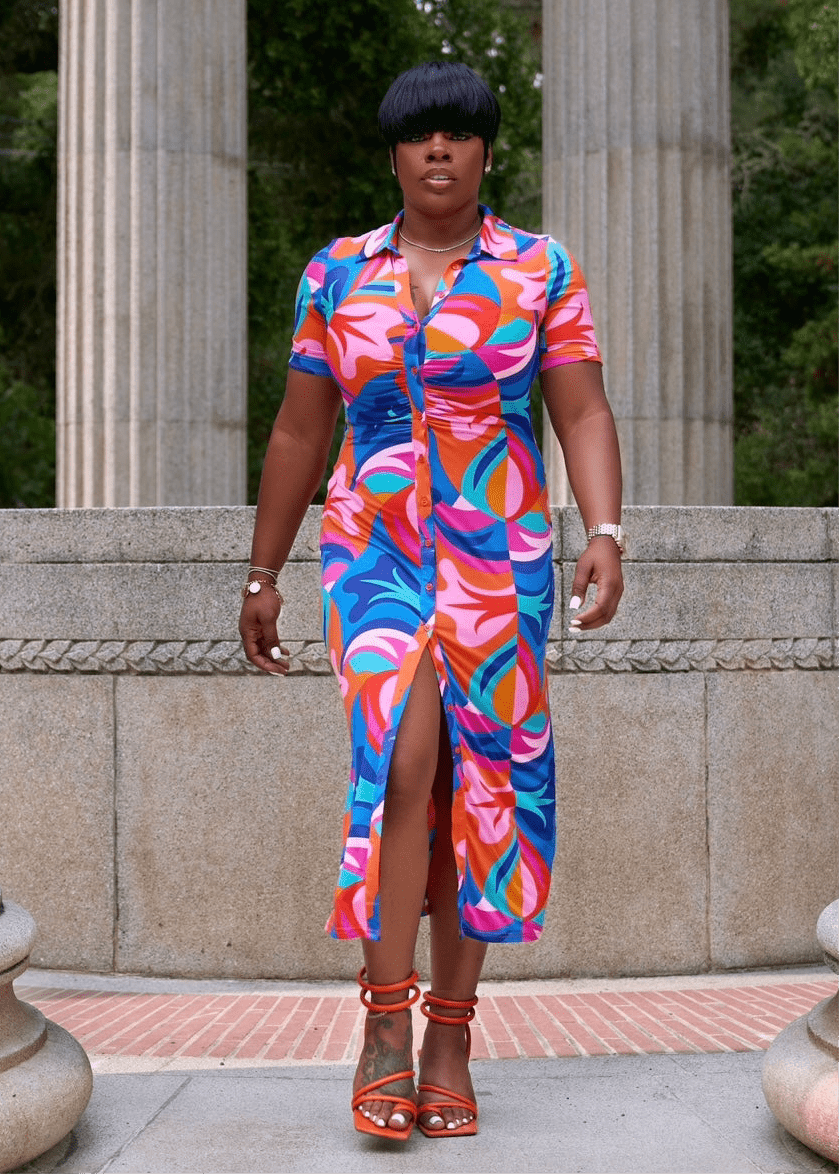Black woman wearing colorful button-up summer dress with V neckline from California boutique – Opulent Gurlz vacation style outfit