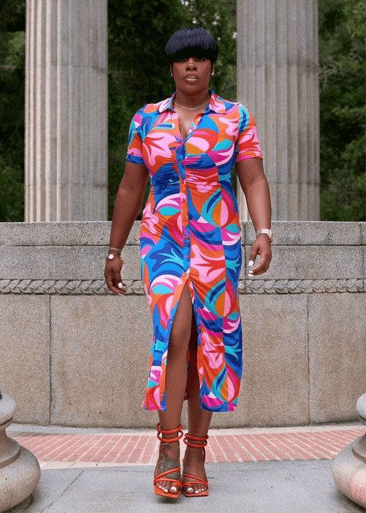 Black woman wearing colorful button-up summer dress with V neckline from California boutique – Opulent Gurlz vacation style outfit