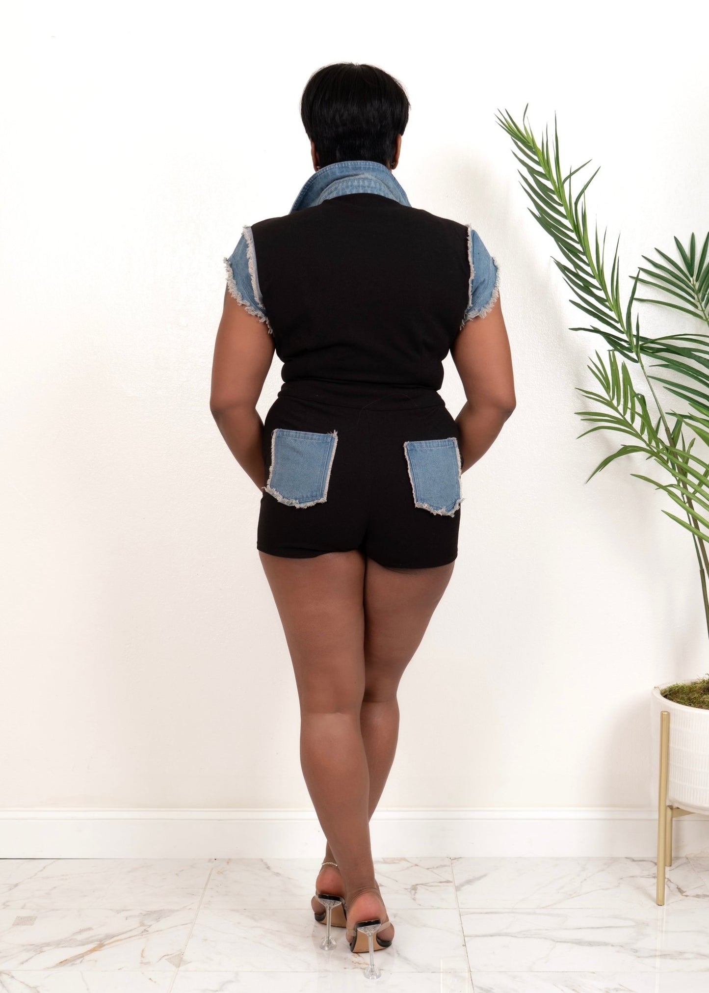Back of black button-up romper with denim pocket details and flattering fit – Opulent Gurlz Boutique