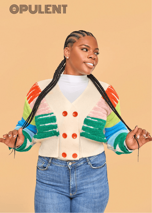 Close-up of model in colorful striped button-up cardigan with solid white turtleneck, styled with high-waisted denim for a vibrant layered look.
