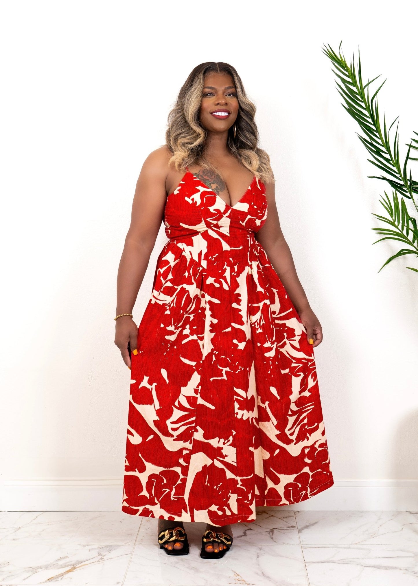 Curvy woman wearing red floral maxi vacation dress– bold summer vacation outfit from Opulent Gurlz boutique