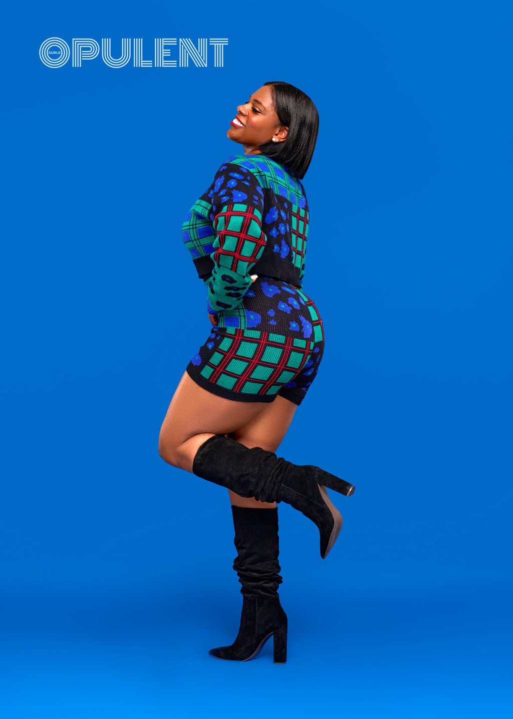 Side angle of bold print jungle knit lounge set with stretch-fit sweater and shorts in rich tones, styled with boots