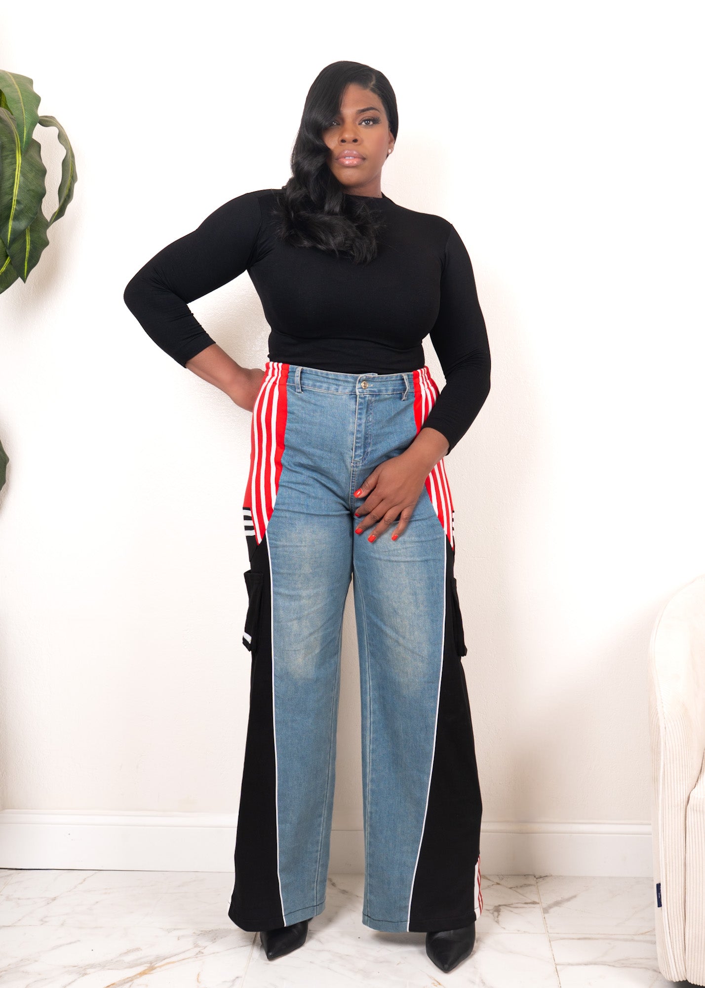 Front view of wide-leg denim contrast track pants with red stripe detailing, black panels, and sporty streetwear fit
