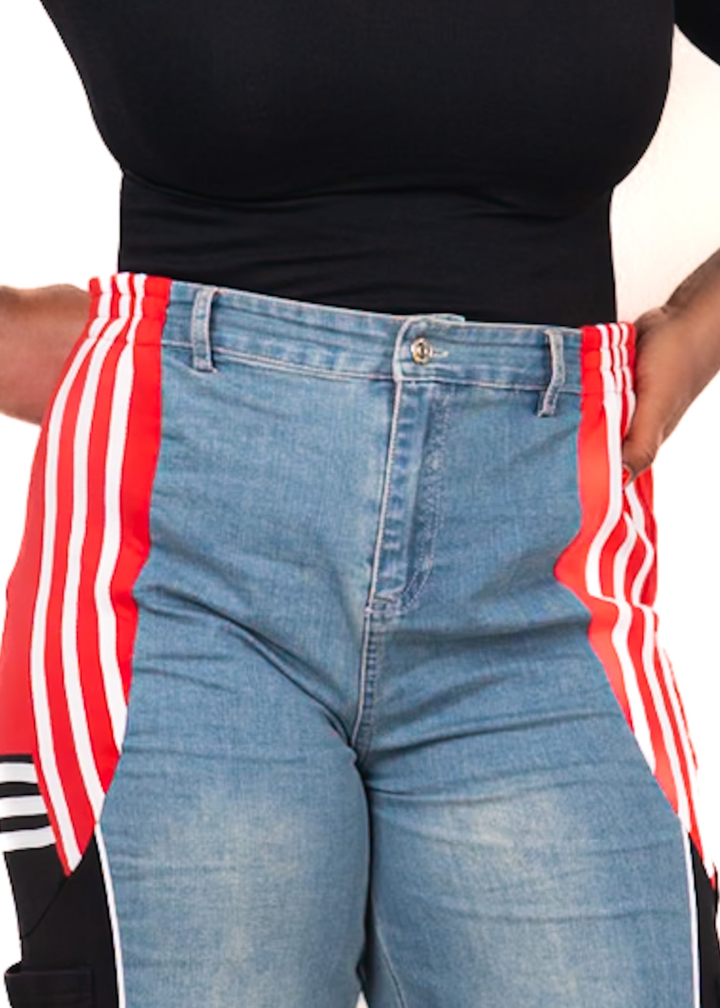 Close-up front waist detail of high-waisted denim contrast track pants with red side stripe panels and structured fit
