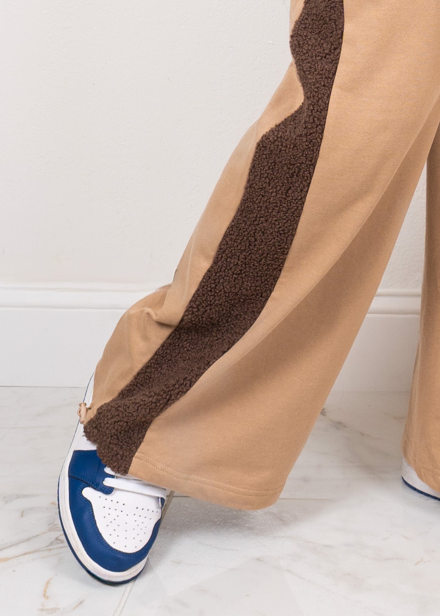 Mocha luxe contrast two-piece set pants side-bottom detail showing adjustable elastic cuff at the hem for customizable fit with sneakers