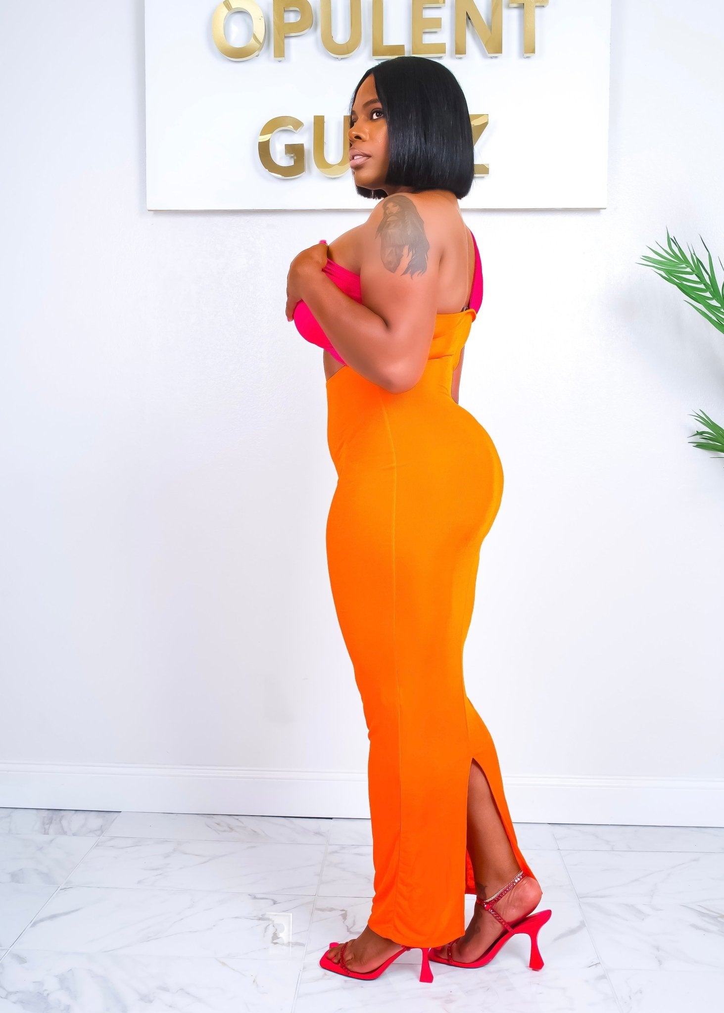 Side view of the Out Of Town Dress showcasing body-hugging fit, maxi length, and curve-accentuating silhouette