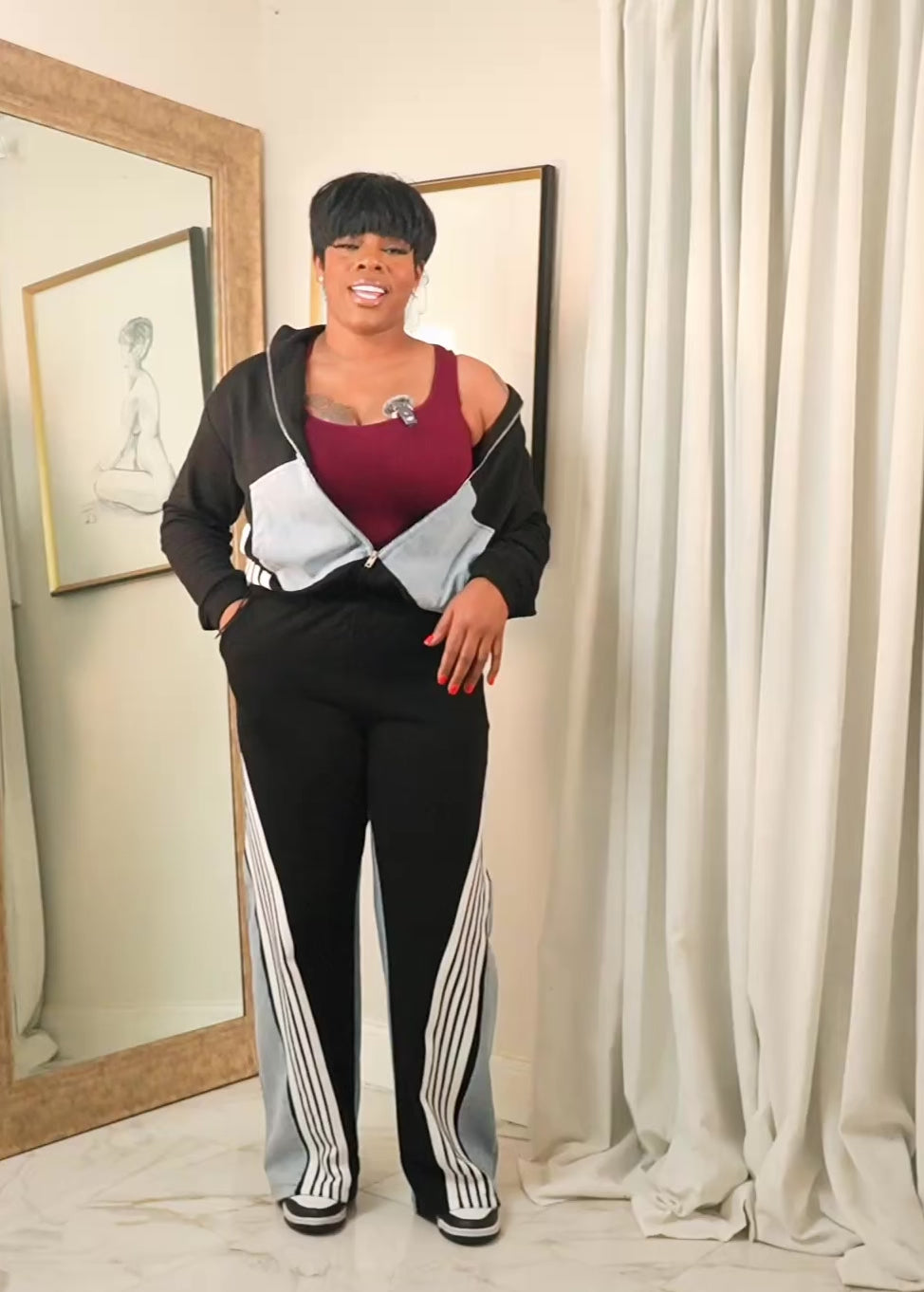 Explanation video detailing the Midnight Motion contrast tracksuit, featuring a zip-up jacket and wide-leg pants, highlighting fit, stretch, and everyday comfort.