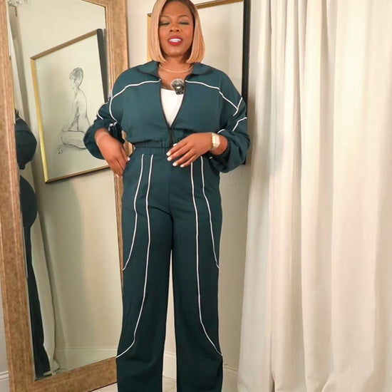Video of women’s hunter green contrast piping track set with cropped zip jacket and wide leg pants, full body try-on showing fit and movement.