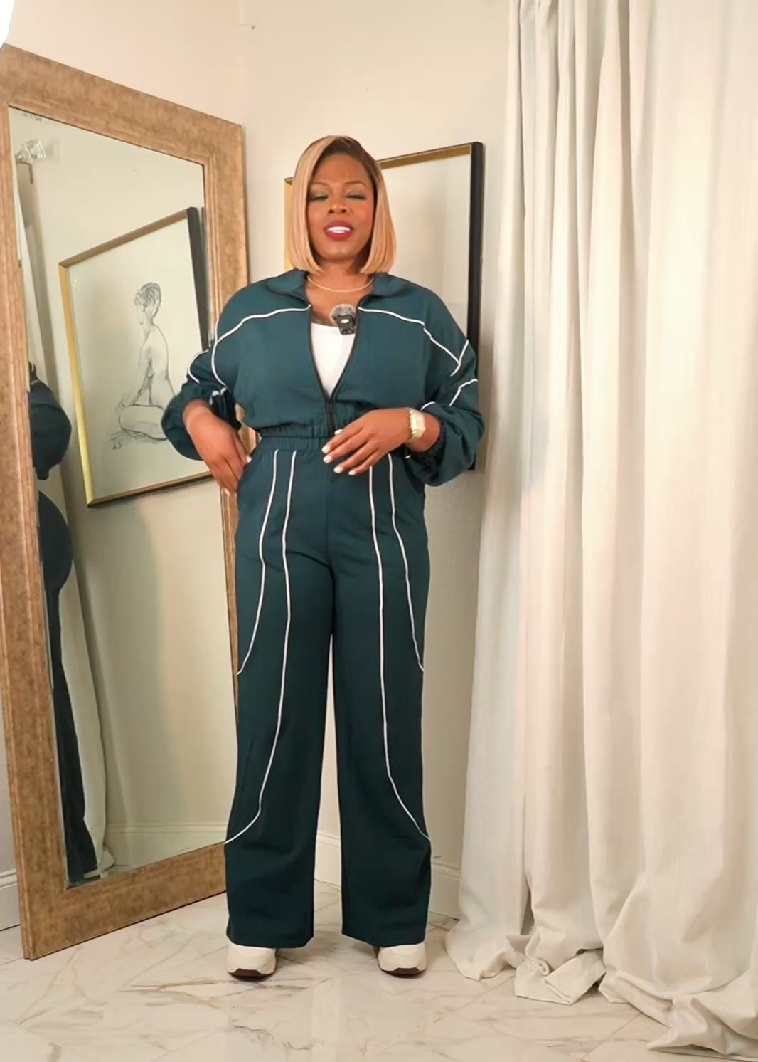 Video of women’s hunter green contrast piping track set with cropped zip jacket and wide leg pants, full body try-on showing fit and movement.