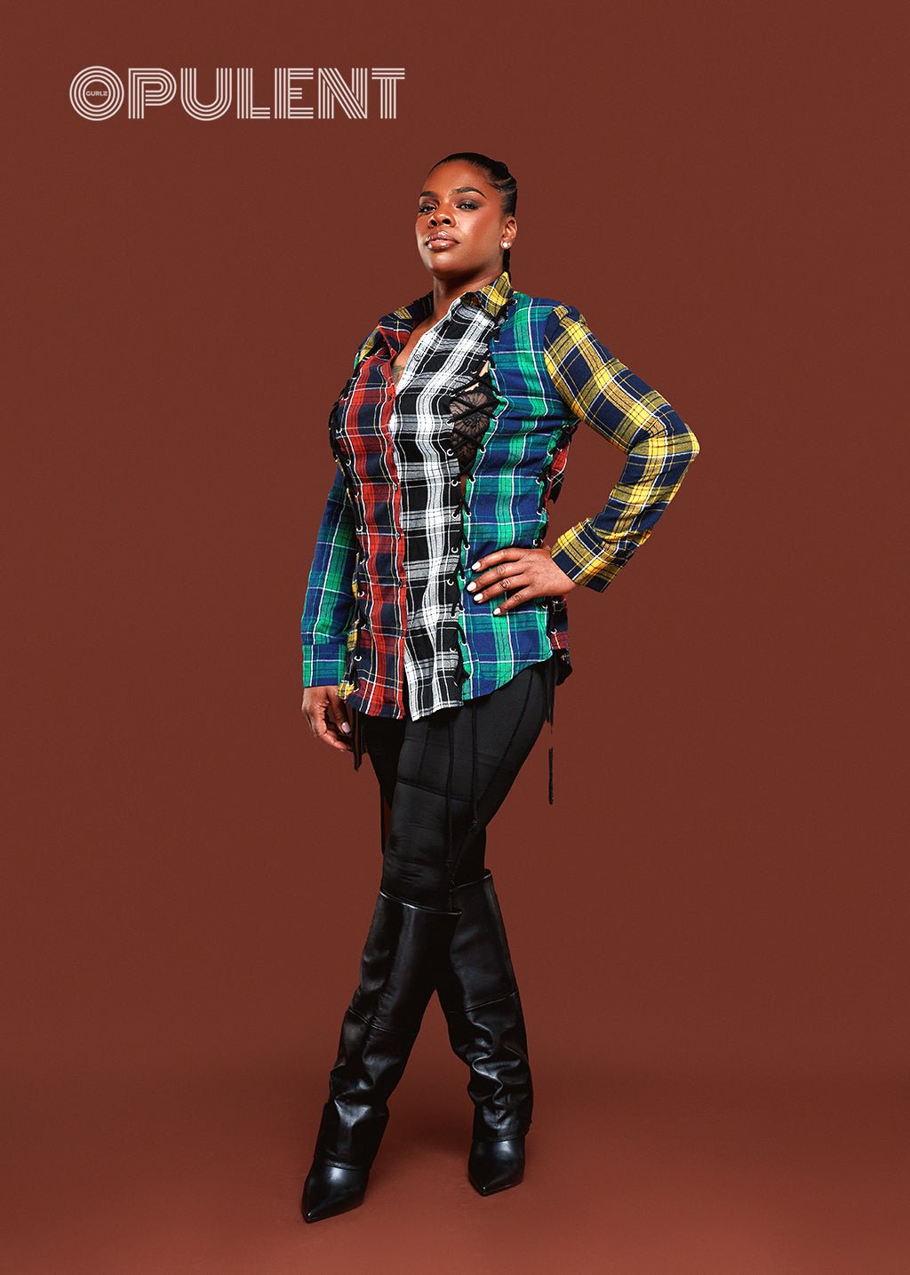 Woman wearing a colorful plaid button-up shirt with drawstring side detail, styled with black leggings and heels